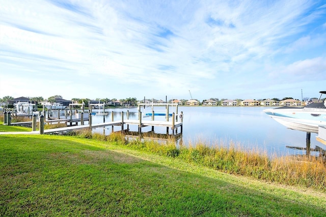 dock area featuring a yard, a water view, and boat lift