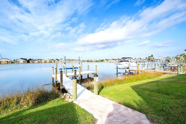 dock area with a yard, a water view, and boat lift