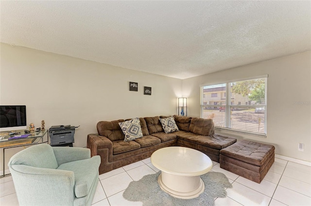 living area with light tile patterned flooring and a textured ceiling