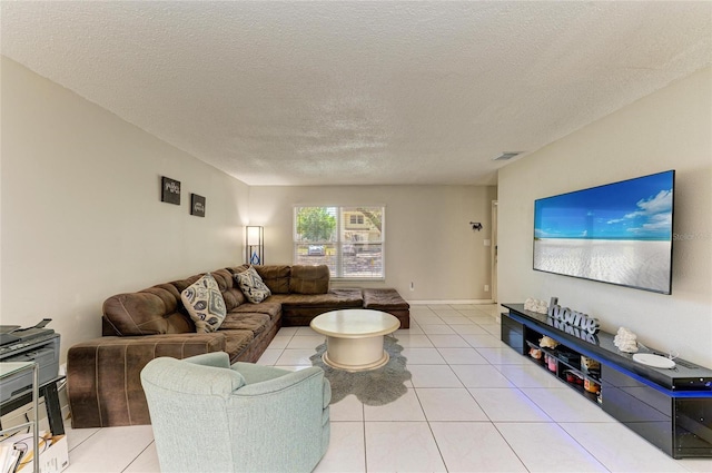 living room featuring light tile patterned floors, visible vents, and a textured ceiling