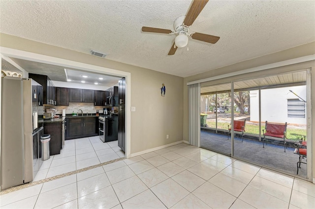 kitchen with a sink, stainless steel appliances, visible vents, and light tile patterned flooring