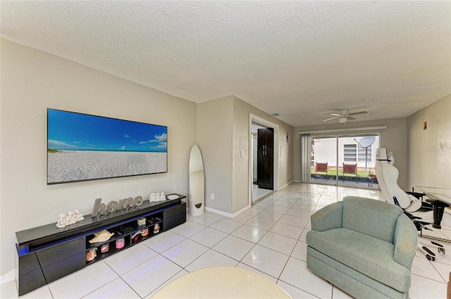 living room featuring tile patterned flooring, ceiling fan, and a textured ceiling