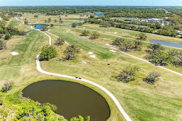 birds eye view of property with a water view and golf course view