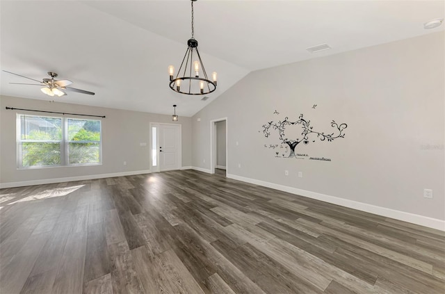 unfurnished room with visible vents, baseboards, vaulted ceiling, ceiling fan with notable chandelier, and dark wood-style flooring