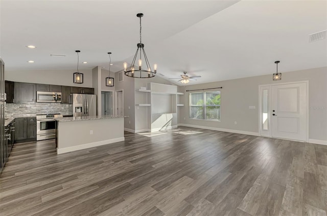 kitchen featuring dark wood-style floors, visible vents, lofted ceiling, appliances with stainless steel finishes, and a center island