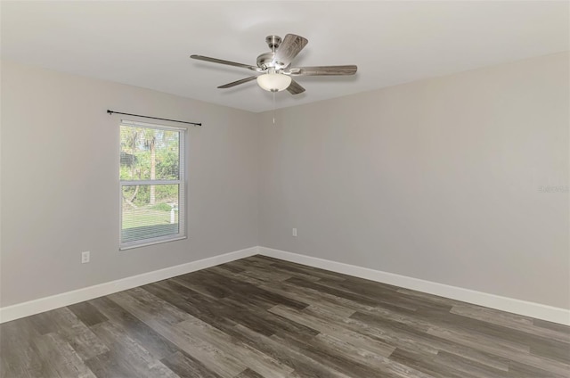 unfurnished room featuring ceiling fan, baseboards, and dark wood finished floors