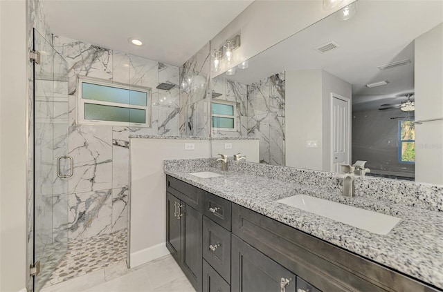 bathroom featuring a sink, a marble finish shower, and visible vents