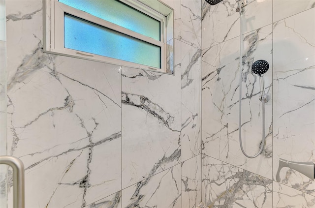 full bathroom featuring a marble finish shower and plenty of natural light