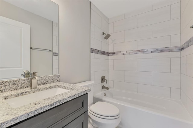 bathroom with toilet, vanity, and  shower combination