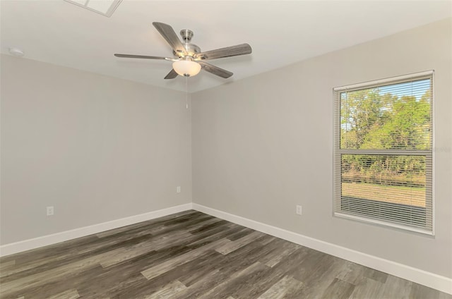 spare room with visible vents, baseboards, ceiling fan, and dark wood-style flooring