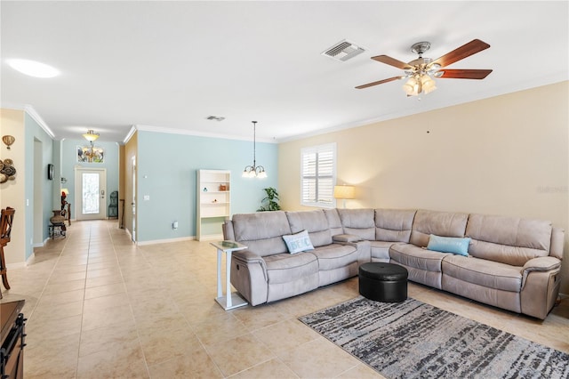 living area featuring light tile patterned floors, visible vents, baseboards, crown molding, and ceiling fan with notable chandelier