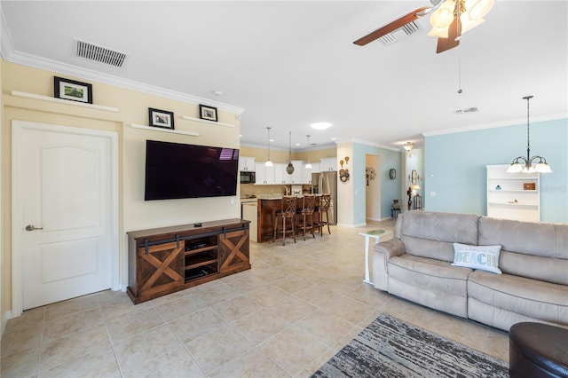 living area featuring crown molding, ceiling fan with notable chandelier, and visible vents