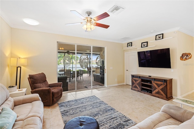 tiled living area featuring visible vents, baseboards, and crown molding