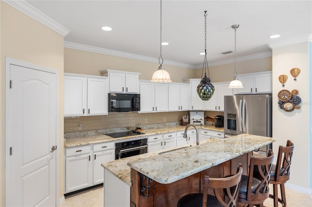 kitchen with visible vents, black appliances, a sink, a kitchen breakfast bar, and crown molding