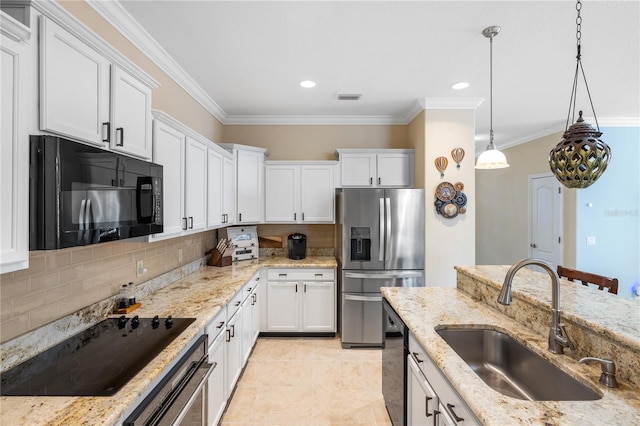 kitchen with visible vents, black appliances, a sink, tasteful backsplash, and white cabinets