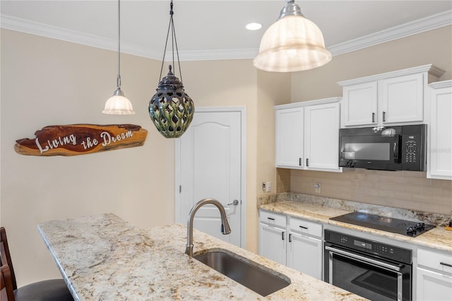 kitchen featuring decorative backsplash, black appliances, ornamental molding, and a sink