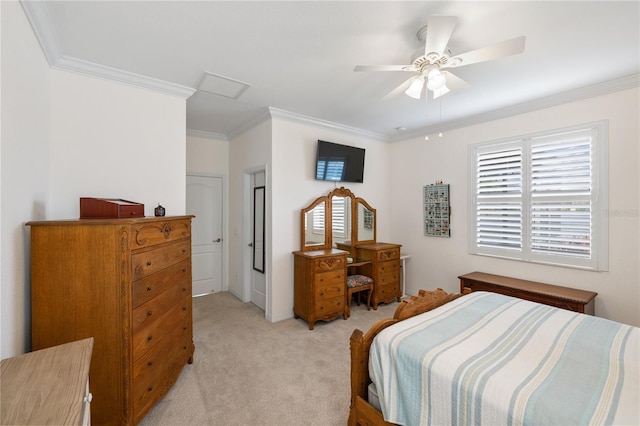 bedroom with light carpet, attic access, a ceiling fan, and ornamental molding