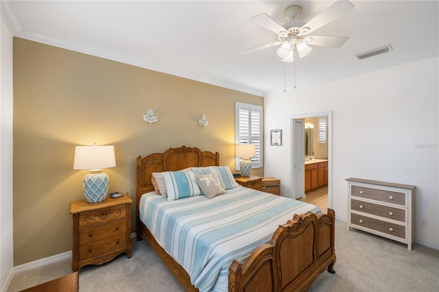 bedroom with connected bathroom, visible vents, light carpet, and ornamental molding