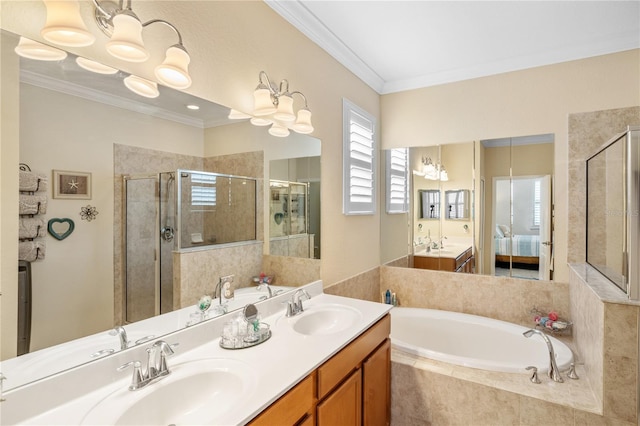 ensuite bathroom with a shower stall, crown molding, a garden tub, and a sink