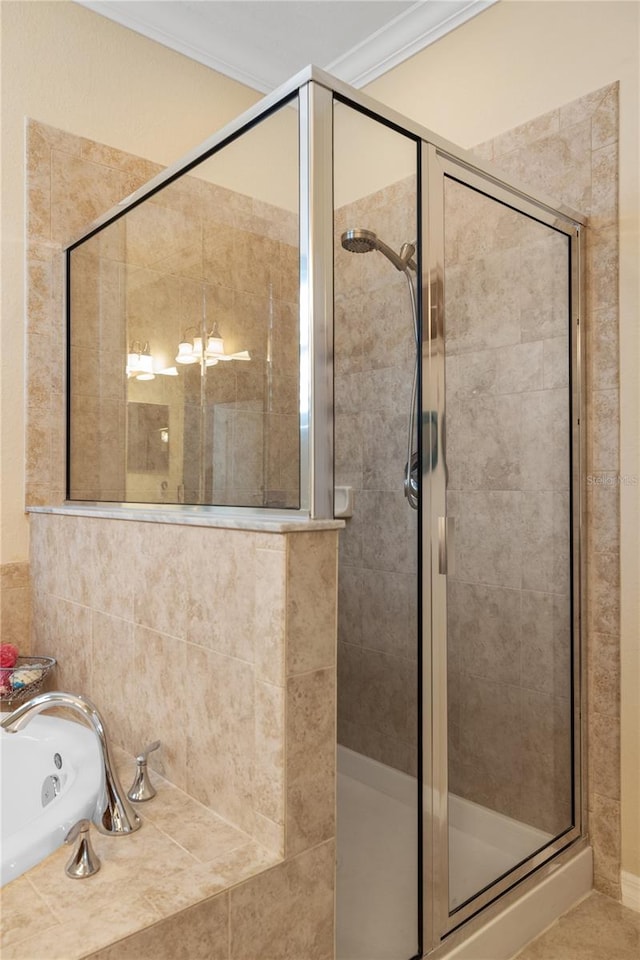 bathroom with a tub with jets, a stall shower, and ornamental molding