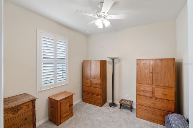 bedroom featuring light carpet, ceiling fan, and baseboards