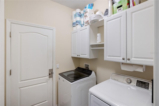 laundry area with cabinet space and independent washer and dryer