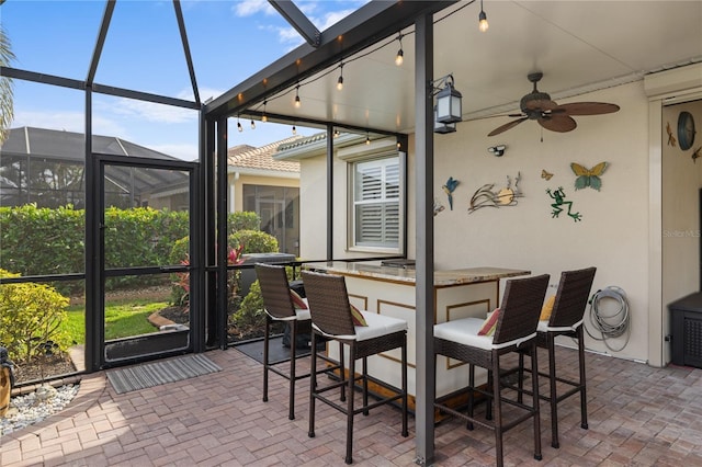 sunroom with track lighting and ceiling fan