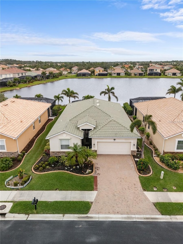 drone / aerial view with a residential view and a water view