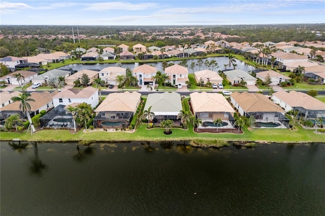 drone / aerial view featuring a residential view and a water view