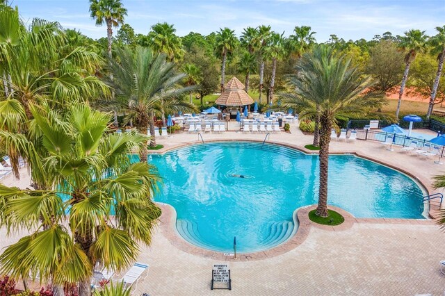 pool featuring a gazebo, a patio area, and fence