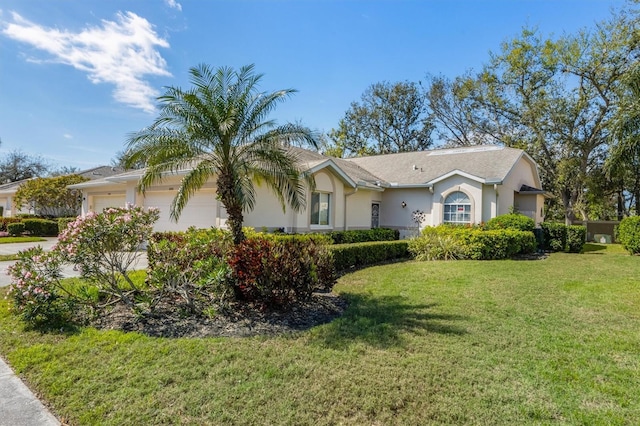 single story home featuring a front lawn, a garage, and stucco siding