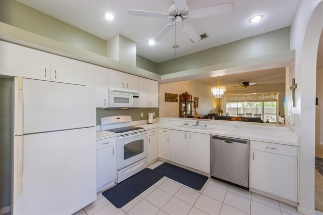 kitchen featuring visible vents, light countertops, ceiling fan with notable chandelier, white appliances, and a sink