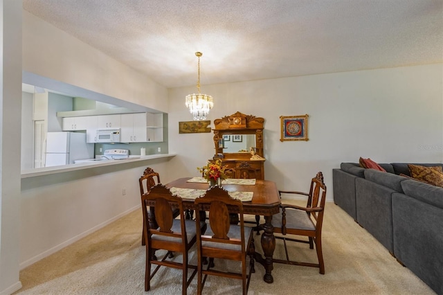 dining room featuring baseboards, light colored carpet, a chandelier, and a textured ceiling