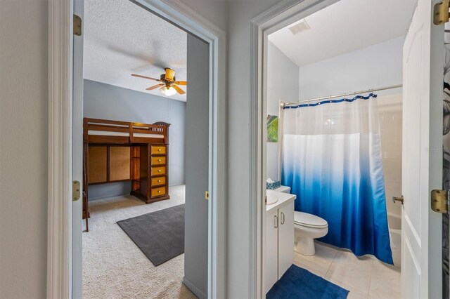 full bathroom with visible vents, toilet, shower / tub combo with curtain, a textured ceiling, and vanity