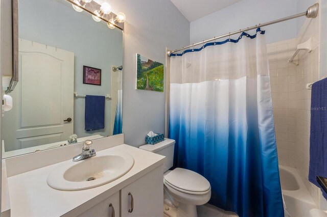 full bath featuring toilet, vanity, and shower / bathtub combination with curtain