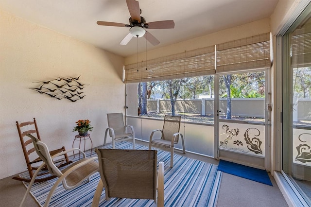 sunroom with plenty of natural light and a ceiling fan