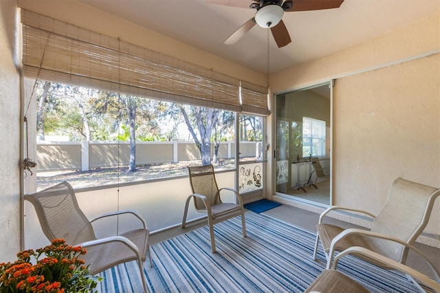 sunroom / solarium with a ceiling fan