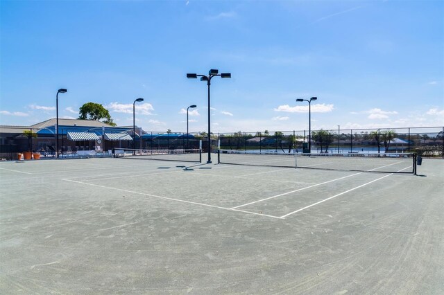 view of sport court featuring fence