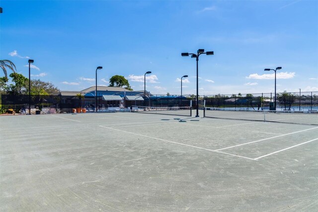 view of tennis court featuring fence