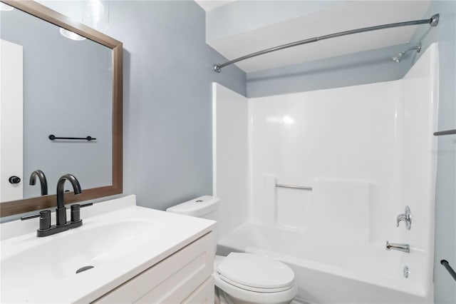 bathroom featuring vanity, toilet, and  shower combination