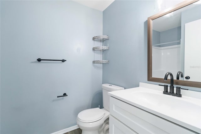 full bath with baseboards, toilet, walk in shower, and vanity