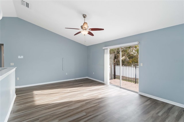 unfurnished room with visible vents, baseboards, lofted ceiling, and wood finished floors