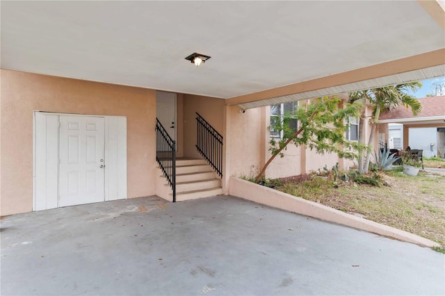 exterior space featuring stairs and unfinished concrete floors