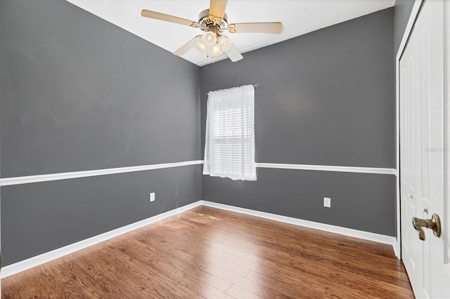 unfurnished room with baseboards, ceiling fan, and wood finished floors