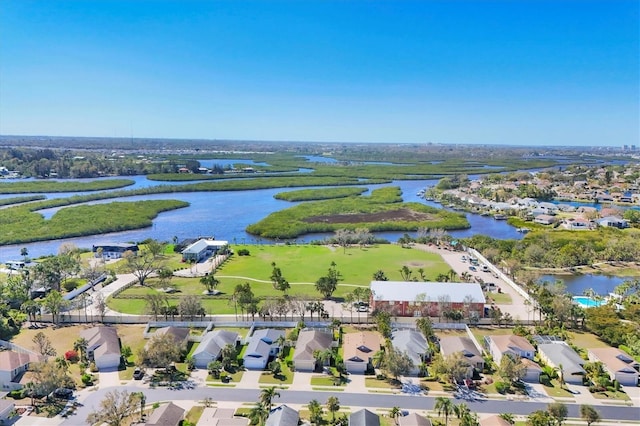 drone / aerial view featuring a water view and a residential view