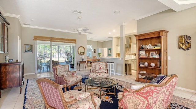 living area featuring visible vents, ornamental molding, a ceiling fan, light tile patterned floors, and baseboards