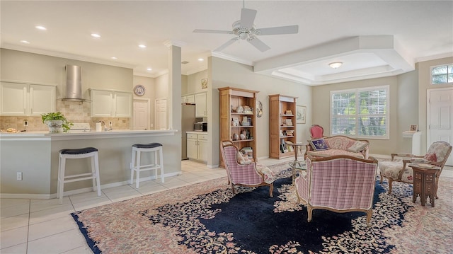 living area featuring crown molding, light tile patterned floors, and recessed lighting