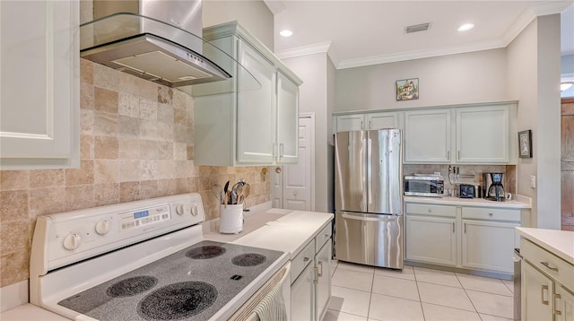 kitchen featuring visible vents, electric stove, freestanding refrigerator, wall chimney exhaust hood, and crown molding