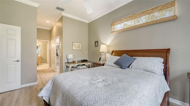 bedroom featuring visible vents, crown molding, baseboards, ensuite bathroom, and wood finished floors