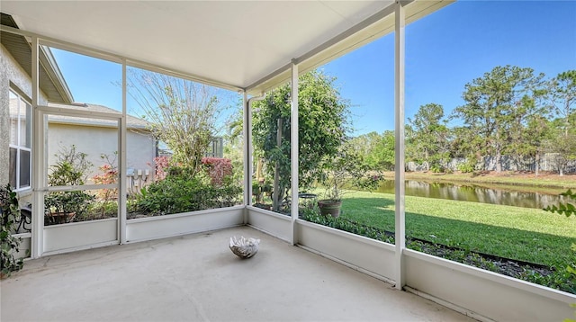 unfurnished sunroom featuring a water view